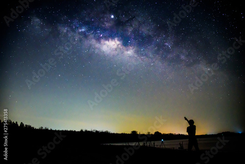 The man standing with milky way   The man point to the milky way