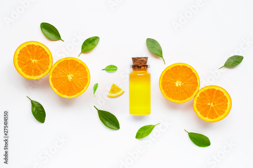 Essential oil with fresh orange citrus fruit with leaves isolated on white