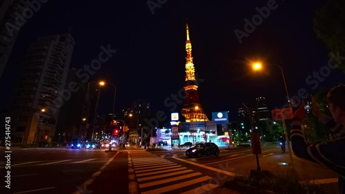 A timelapse at the crossing behind the high tower at night panning. Minato district Tokyo / Japan - 04.27.2019 : Here's called Tokyo tower. camera : Canon EOS 5D mark4 photo