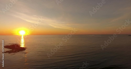 Beautiful sunset in Hustadvika, Norway. You can see two/three boats in the horizon. photo