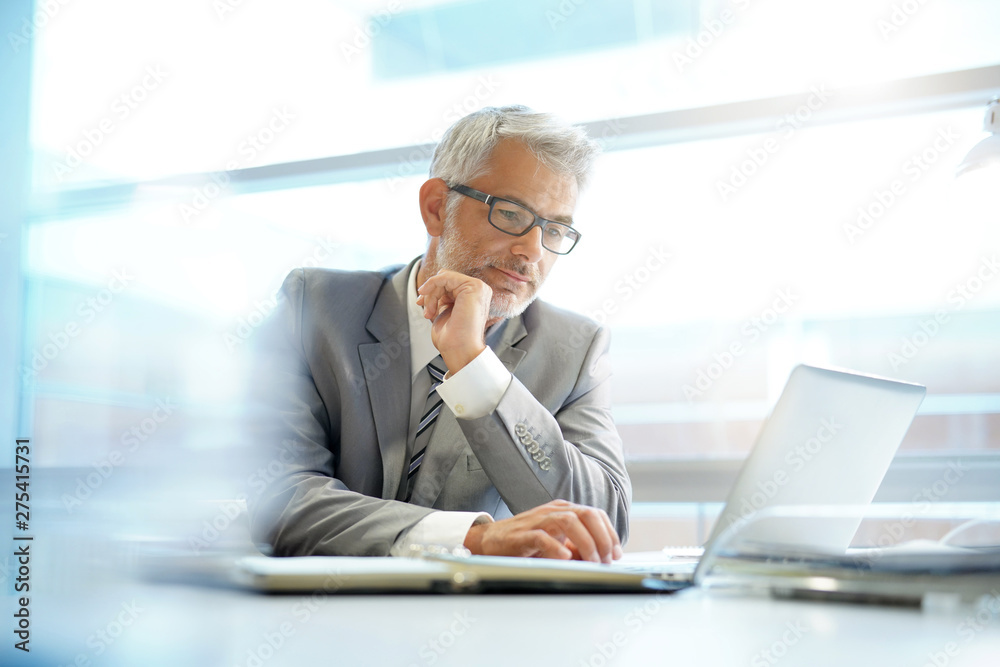 © goodluz - Stylish businessman working at desk in contemporary office © goodluz - Stylish businessman working at desk in contemporary office