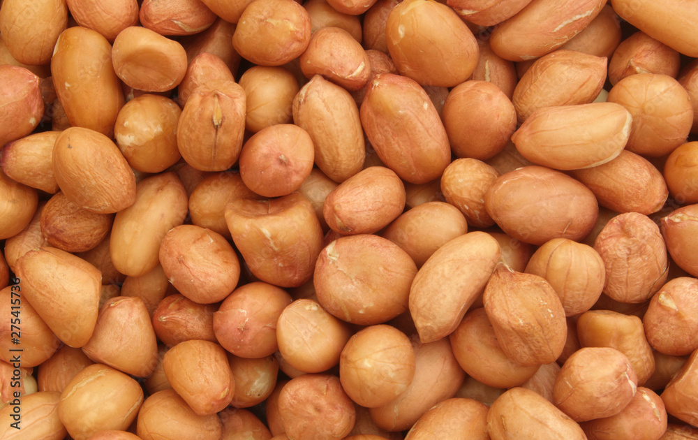 Peanuts background, many raw peanuts close up Peanuts background, many raw peanuts close up