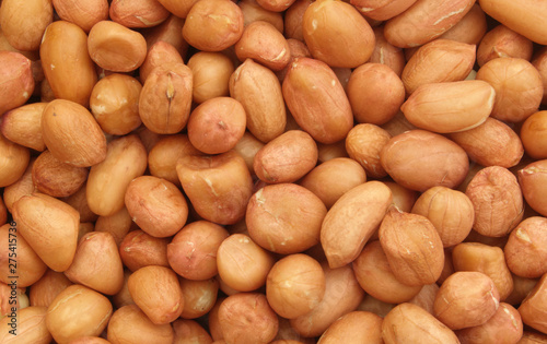 Peanuts background, many raw peanuts close up