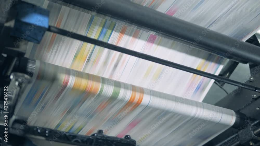 Fake news concept. Printing press is issuing dyed paper piece