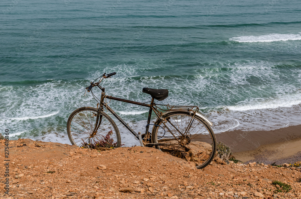 Fototapeta premium Africa Morocco vintage bike on a hillside on the shores of the Atlantic Ocean