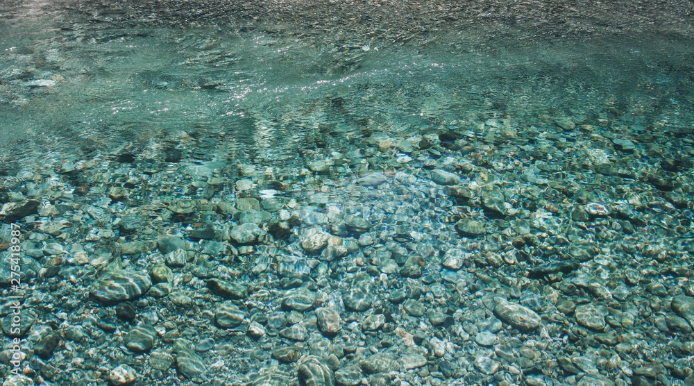 Stones under blue water