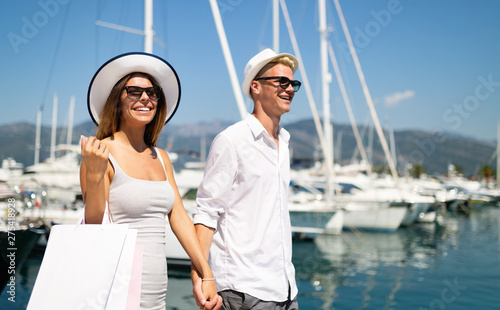 Happy couple on summer vacation shopping and sightseeing