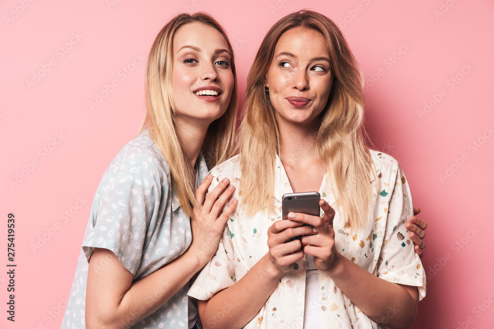 Two attractive blonde girls wearing summer outfit Two attractive blonde girls wearing summer outfit