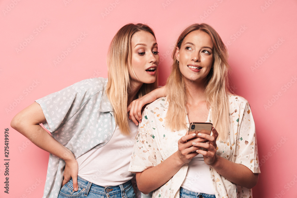 Two attractive blonde girls wearing summer outfit Two attractive blonde girls wearing summer outfit
