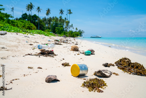 Environmental trash disgarded on idyllic beach