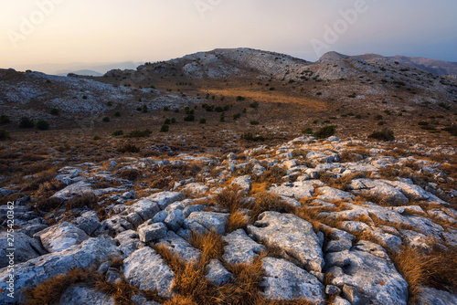 Panoramic view of the rock formations and grass on the top of Monte Albo in Sardinia, Italy
