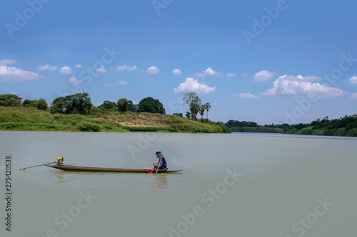 Daylight in countryside thailand - Fisherman floating on fishing boat over chao pra ya river to keep the fishing net , rustic life