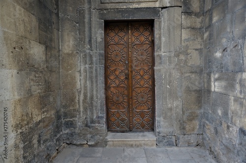 old wooden door in stone wall