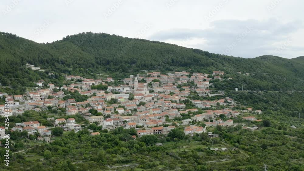 Smokvica village on Island of Korcula, wide establishing shot pan over small traditional town 4k