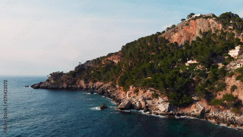 Drone Video Close to the Water, Waves Collapsing on the Rocks, Houses in the Hillside. Mallorca. Drone Video Close to the Water, Waves Collapsing on the Rocks, Houses in the Hillside. Mallorca.