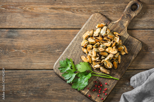 Mussel meat on a wooden Board on a wooden table. Rustic style