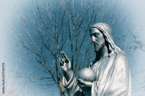 Fragment of statue Jesus Christ. He holds the sphere with a cross as a symbol of the trusteeship of Christianity above the earth. Special effect  faith concept 