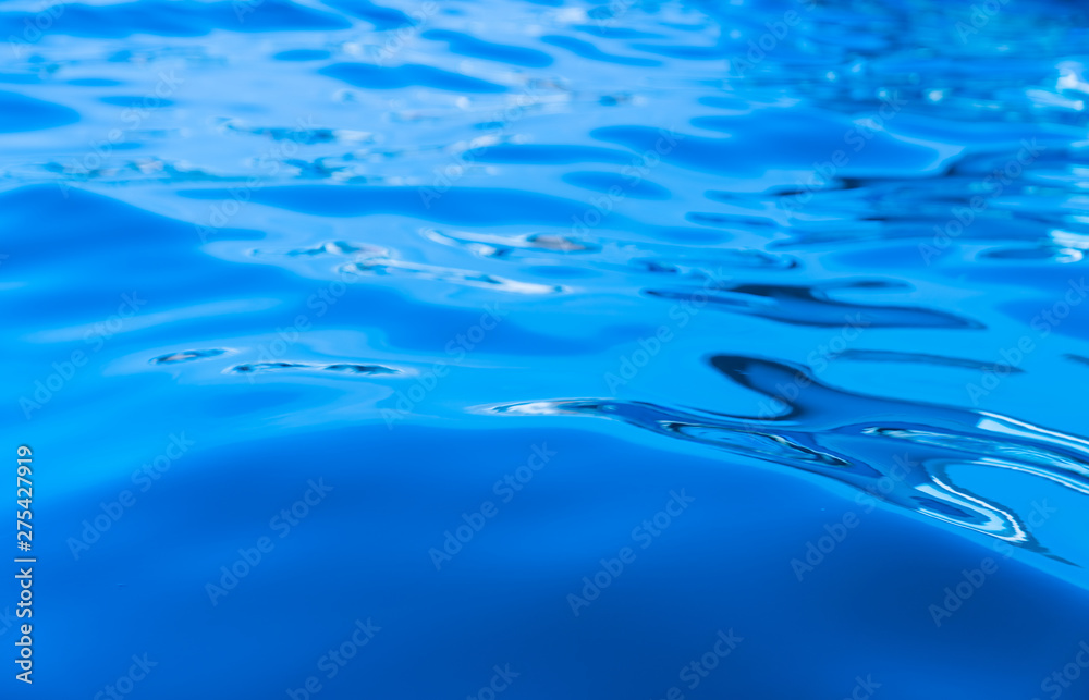 Calm swirlling blue water surface