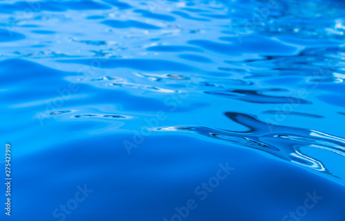 Calm swirlling blue water surface