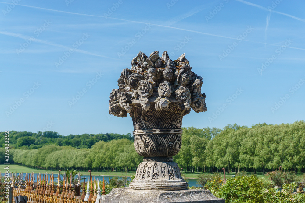 old statue with stone flowers in the park