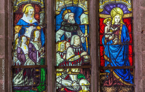 France, Brittany, Le Faouet, Chapelle Sainte Barbe, detailed view of the Renaissance style stained glass representing the life of Saint Barbara photo