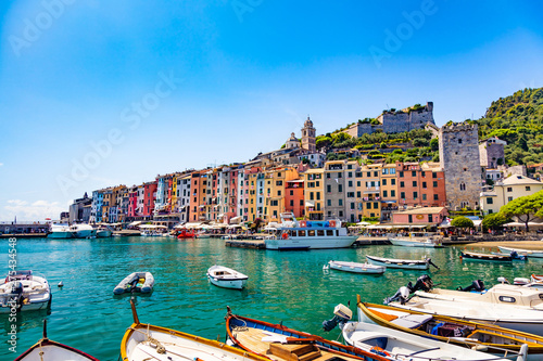 Portovenere, Cinque Terre, Liguria, Italy - 09 August 2018 - Panorama of colorful picturesque harbour of Porto Venere with San Lorenzo church, Doria Castle and Gothic Church of St. Peter photo