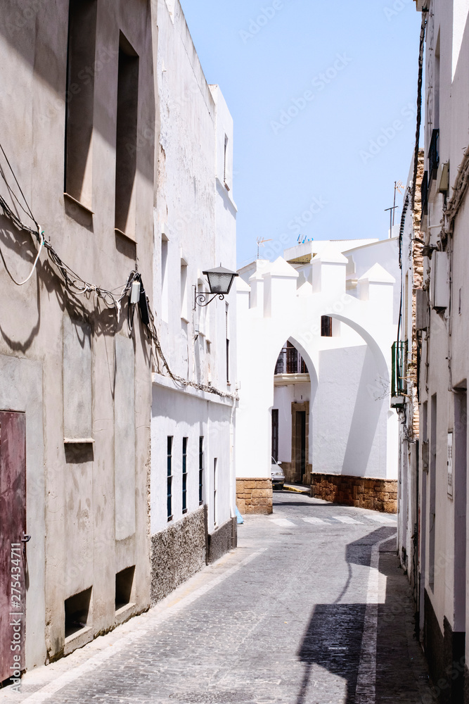 The medieval Arab white city of Rota, Spain. Old street, perspective