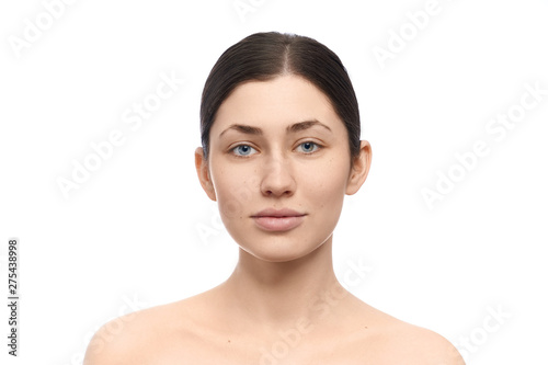 Woman without makeup posing on white isolated background