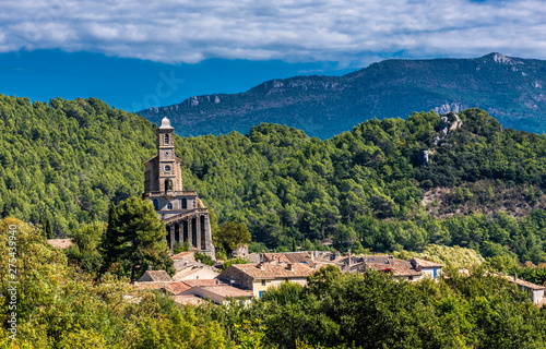 France, Drome, The Provencal Baronnies Regional Natural Park, Pierrelongue, rocky peak restructured in the 19th century to recieve the church Notre Dame de la Consolation photo