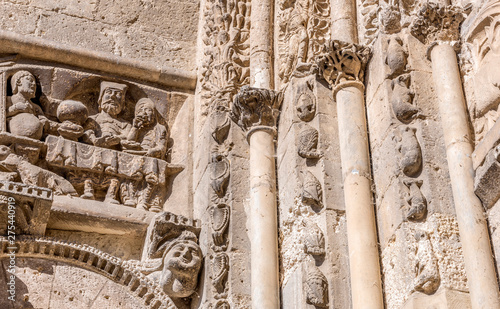 France, Tarn-et-Garonne, Saint Pierre f Moissac abbey (Saint James way, UNESCO World Heritage), detailed view of the gate (12th century) arch moulding representing animals climbing to the sky and palmettes, and the Richman and Lazarus on the side walls photo