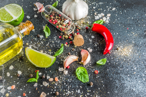 Cooking food stone concrete background with spices, olive oil, garlic, onion, pepper, herbs, basil. Top view copy space