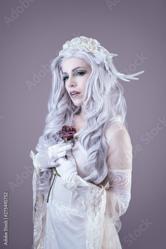 Young princess holding a rose in her hands