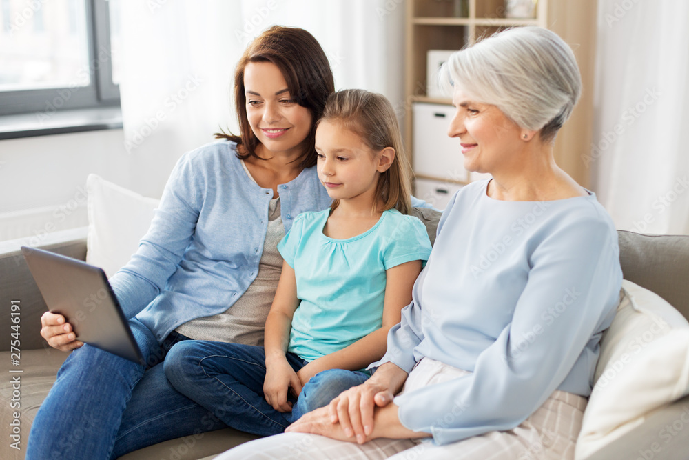 family, generation and technology concept - happy mother, daughter and grandmother with tablet computer at home family, generation and technology concept - happy mother, daughter and grandmother with tablet computer at home