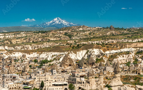 Turkey, Goreme National park and rock sites of Cappadocia, city of Uchisar and snow-covered Erciyes Mountain (former volcano, 3917 meters high) (UNESCO World Heritage) photo