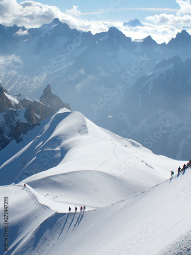 France, haute savoy, Chamonix, Mont blanc range, some alpinists are hiking on the snow edge of the aiguille du midi