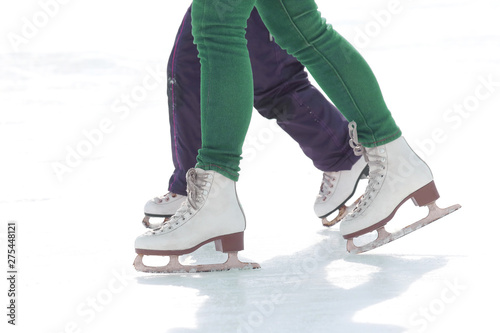child and adult skates at the ice rink.. vacation hobbies and sports