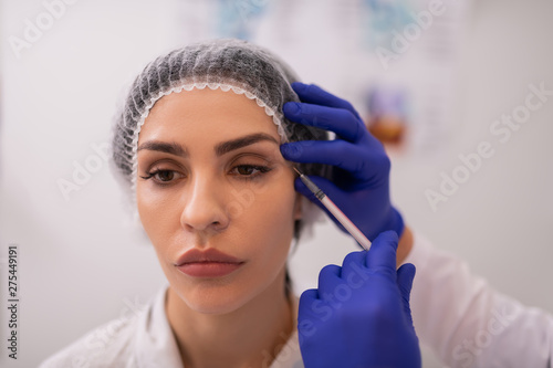 Businesswoman with natural makeup having botox injections