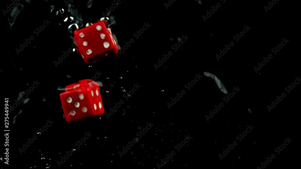 Rolling two red dice splashing in water
