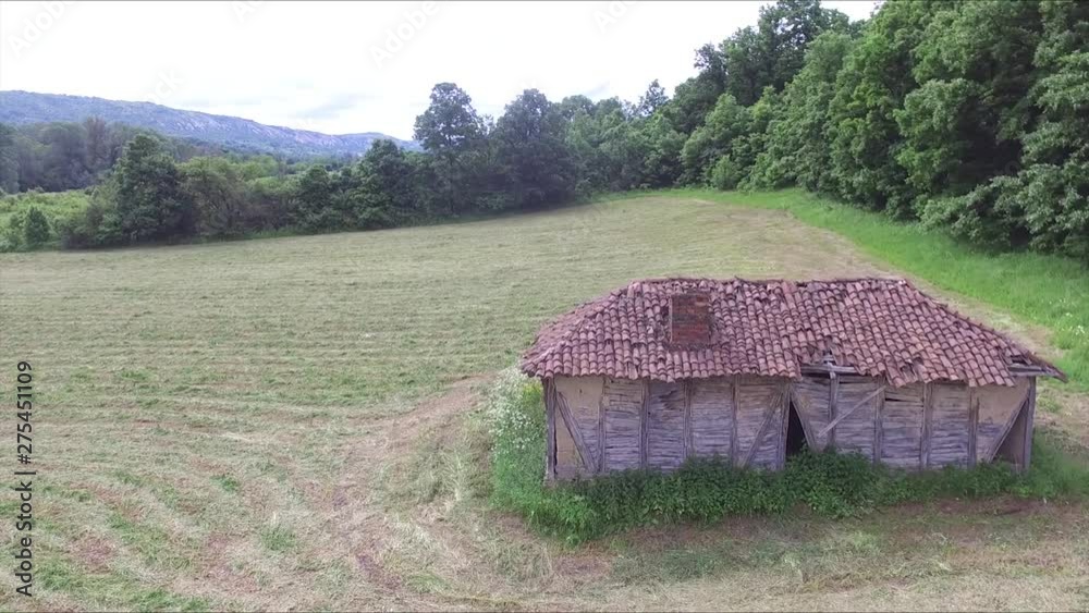 Flight above old and abandoned huts in the middle of the meadow Flight above old and abandoned huts in the middle of the meadow