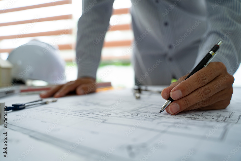 Asia Young man engineer working on blueprint in office. asian men engineer working on architects project. Young architect work project. Asia Young man engineer working on blueprint in office. asian men engineer working on architects project. Young architect work project.