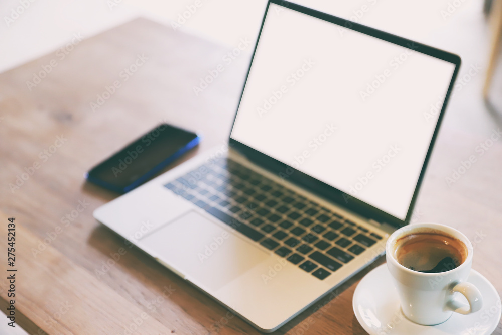 Cup of coffee and laptop phone on wooden background. Cup of coffee and laptop phone on wooden background.