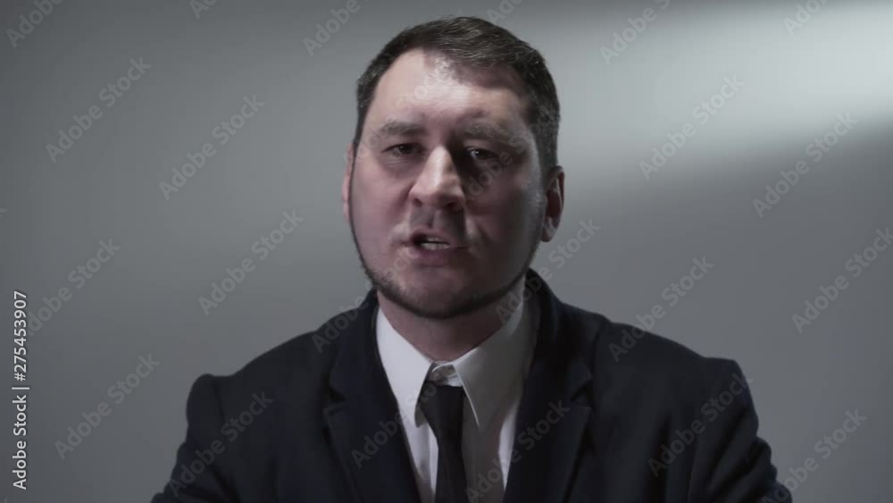 Portrait of man in a business suit who reading a rap, sings or quickly says something while actively gesticulating. Portrait of man in a business suit who reading a rap, sings or quickly says something while actively gesticulating.