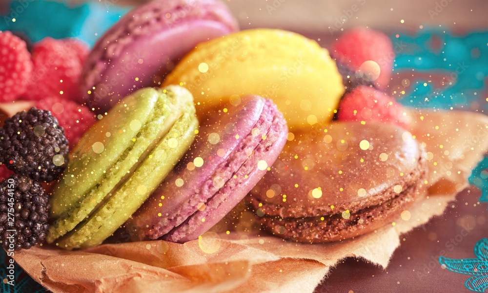 Delicious colorful macaroons with berries on parchment paper Delicious colorful macaroons with berries on parchment paper