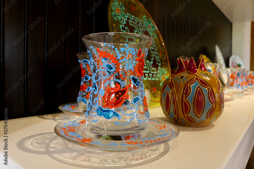 Small tea glass armudu corresponding plate with decoration on it. Turkish Azeri traditional pear-shaped glass for black tea.