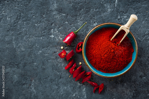 Chili pepper powder on dark background with copy space top view photo