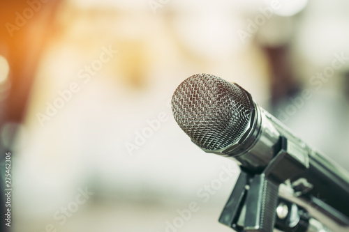 Retro Microphones with lens light flare on front stage in pub bar or restaurant. Classic sing a song in evening and night show on black light background.