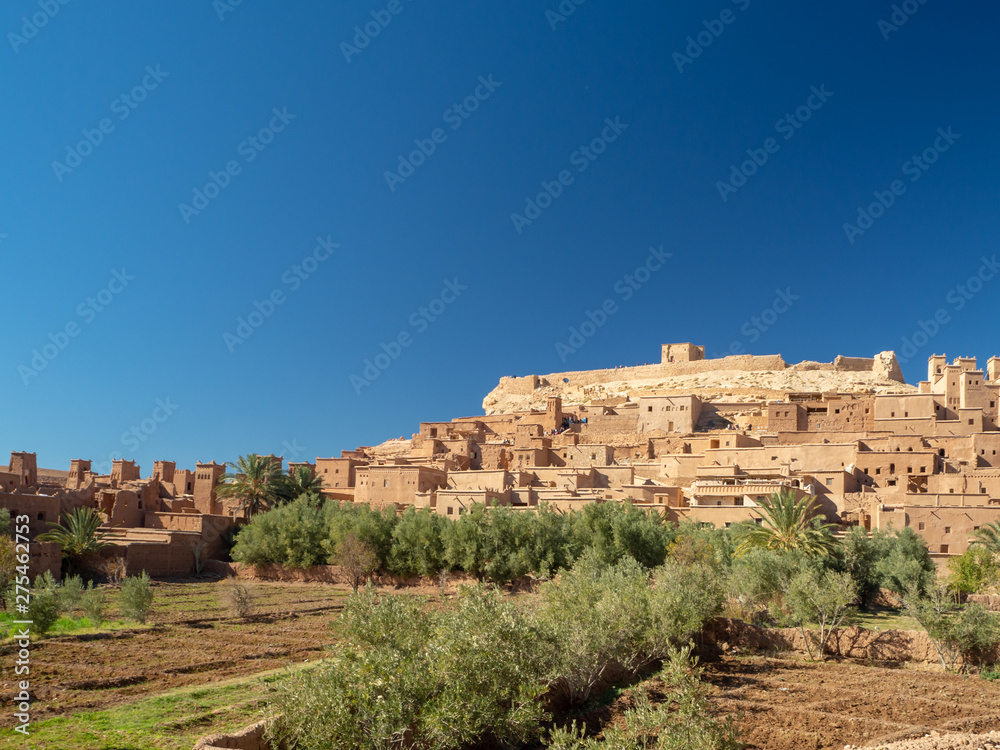 Ait Ben Haddou Kasbah, old medieval town in Morocco desert, castle fort gate, clay mud houses ruins, river in the mountiains