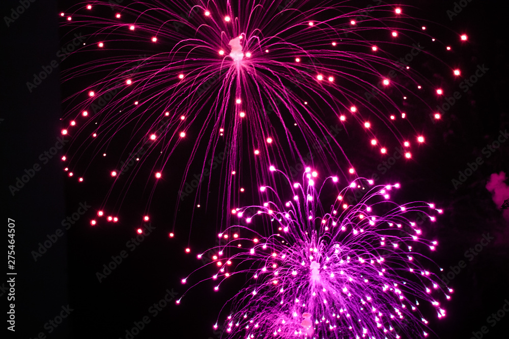 Fototapeta premium Beautiful sparks from fireworks in sky at night