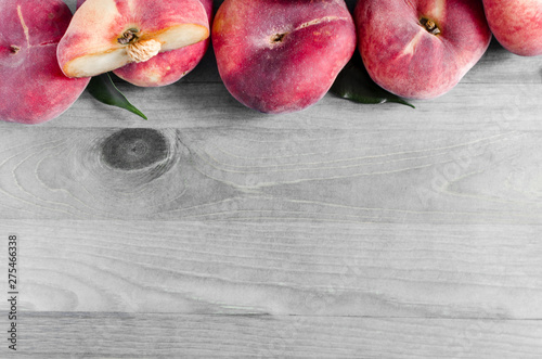 flat peaches on wooden background Fig peaches Kopi space photo