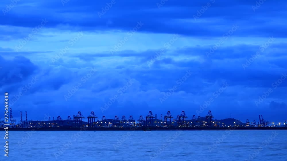 seaport crane moving cargo and container and dark blue cloud passing time lapse seaport crane moving cargo and container and dark blue cloud passing time lapse